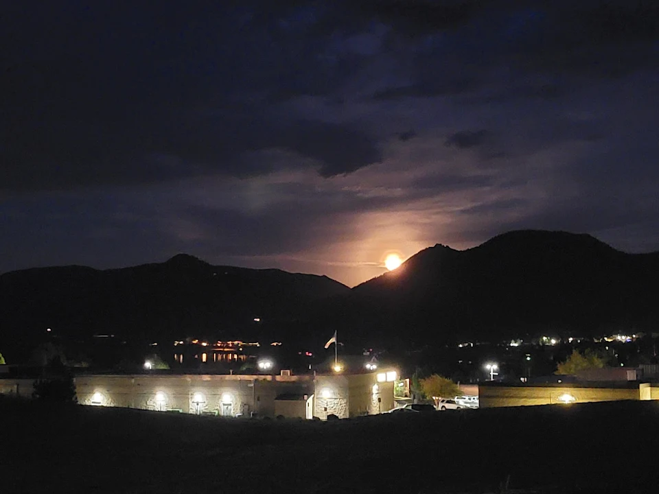 Moon rising over the rocky mountains