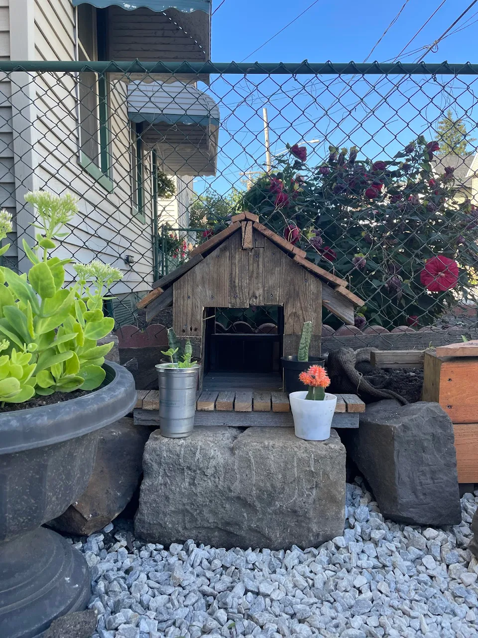 a tiny cat shelter made of reclaimed fence