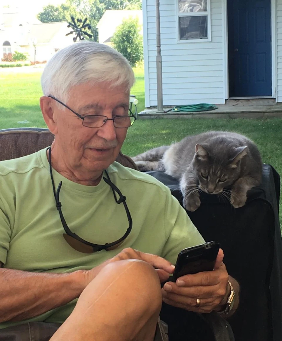 My dad showing Weber the cat something on his phone