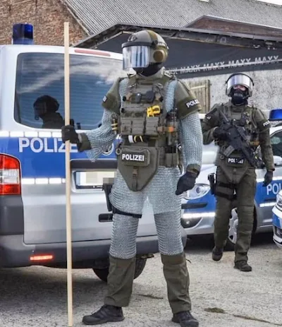 A German police officer wears a chain mail suit to deter knife attacks